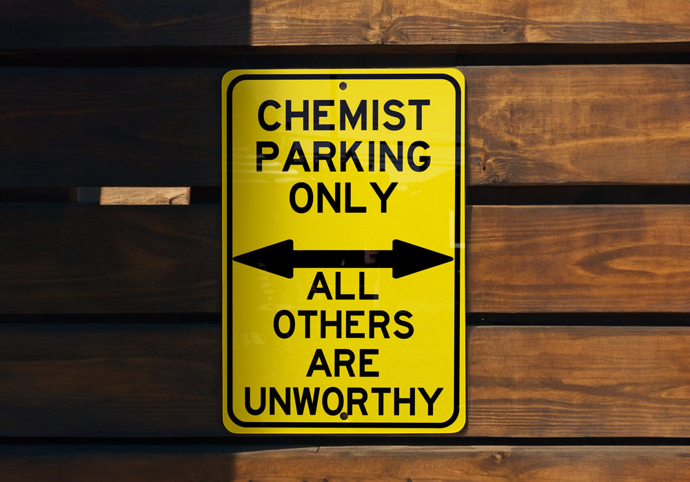a yellow and black sign on a wooden wall