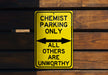 a yellow and black sign on a wooden wall