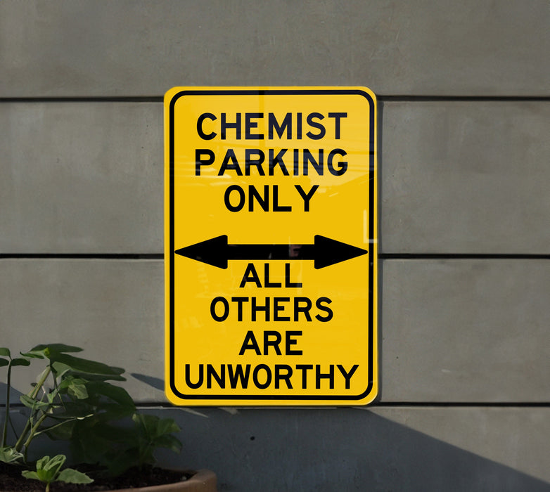 a yellow and black sign that says, chemist parking only all others are un