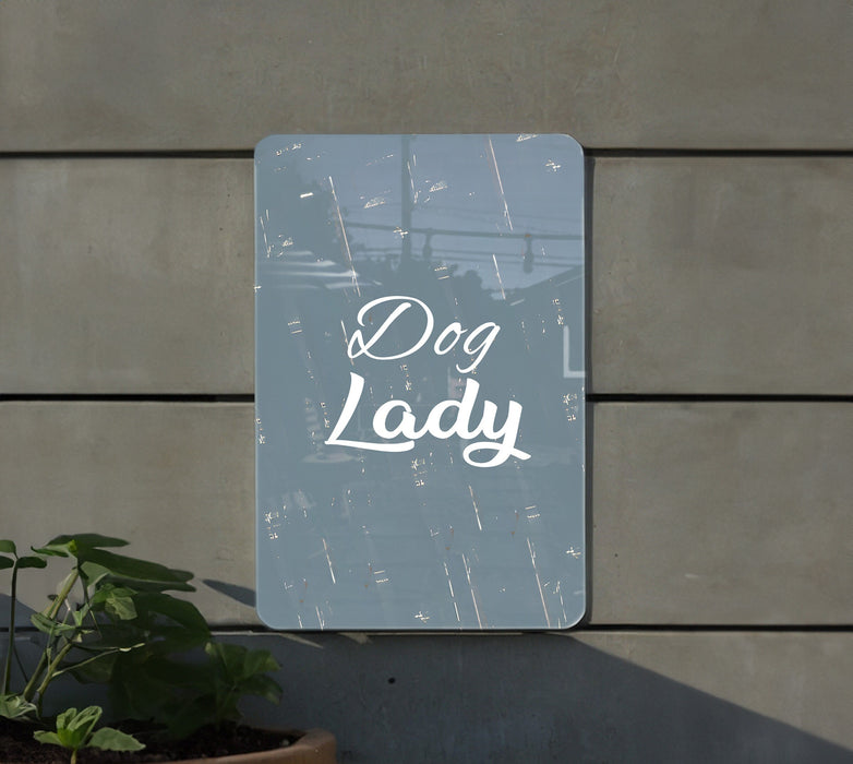 a sign that says dog lady next to a potted plant