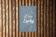 a sign on a wooden wall that says dog lady