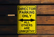 a yellow sign that says director parking only all others are unworthyly