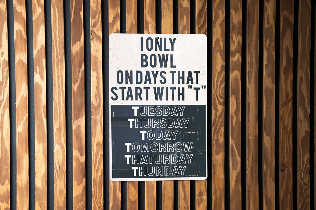 a sign on the side of a building that says i only bowl on days that