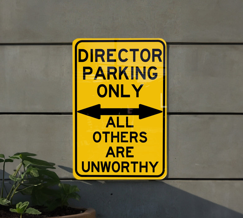 a yellow sign that says director parking only all others are unworthyly