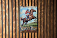 a vintage race day sign hangs on a wooden wall