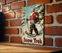 a picture of a man on skis on a brick wall