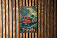 a red train traveling down train tracks next to a wooden wall