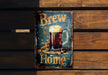 a metal sign with a glass of beer on it