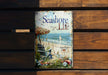 a wooden bench with a sign that says seashore life