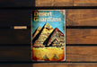 a tin sign with a picture of a pyramid on it