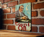 a picture of a man on a sign on a brick wall