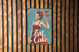 a sign on a wooden wall that says eat cake