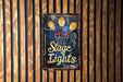 a sign on a wooden wall that says stage lights