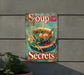 a soup sign hanging on the side of a building
