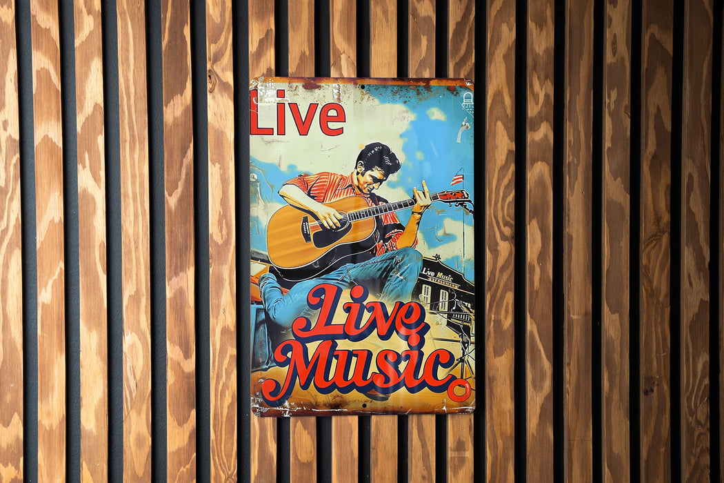 a poster of a man playing a guitar on a wall