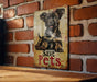 a picture of a dog on a sign on a brick wall