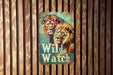 a sign on a wooden wall that says wild watch