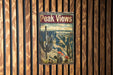 a sign on a wooden wall that says peak views