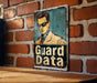 a sign on a brick wall that says guard data