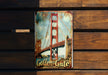 a picture of a golden gate sign on a wooden bench