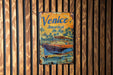 a sign on a wooden wall that says venice america