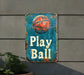a sign that says play ball hanging on a wall