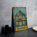a metal sign with a picture of a house on it