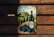 a bottle of wine sitting on top of a wooden bench