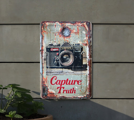 a sign on the side of a building that says capture truth