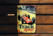 a sign on a wooden wall that says track speed