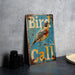 a bird sign sitting on top of a table