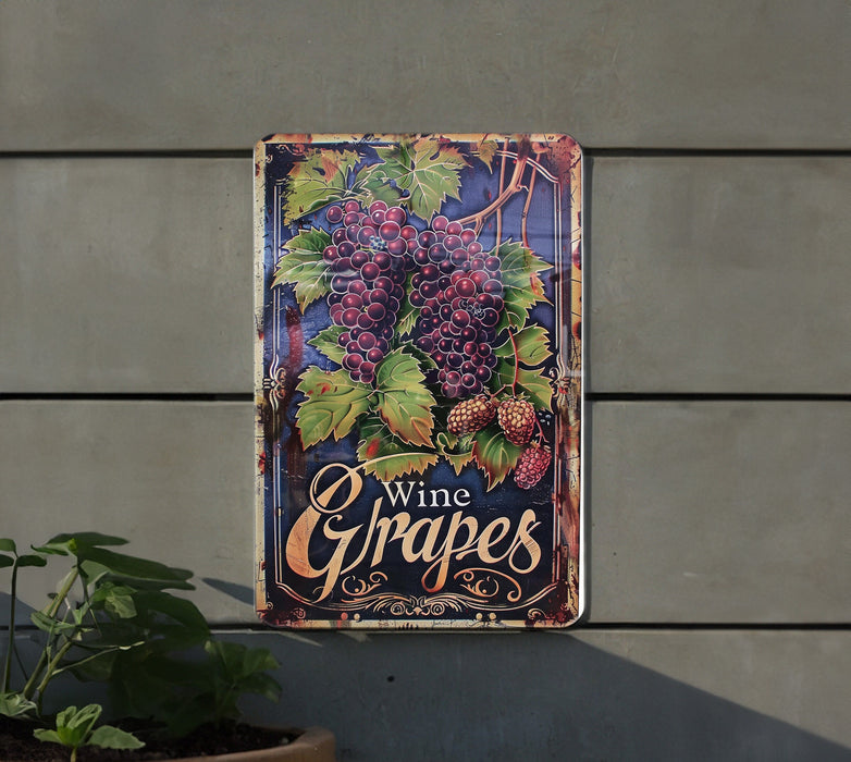 a metal sign with grapes hanging on a wall