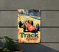 a metal sign with a racing car on it