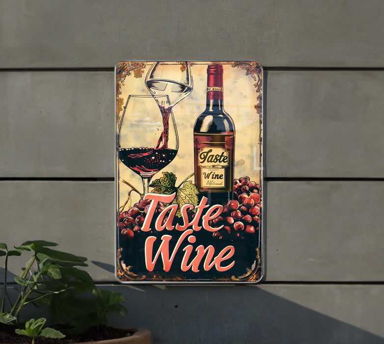 a metal sign with a bottle of wine and a glass of wine