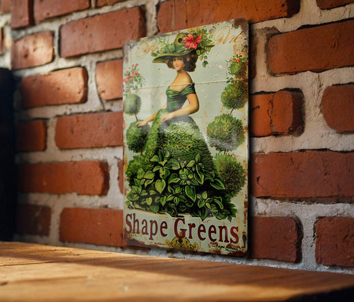 a picture of a woman in a green dress on a brick wall