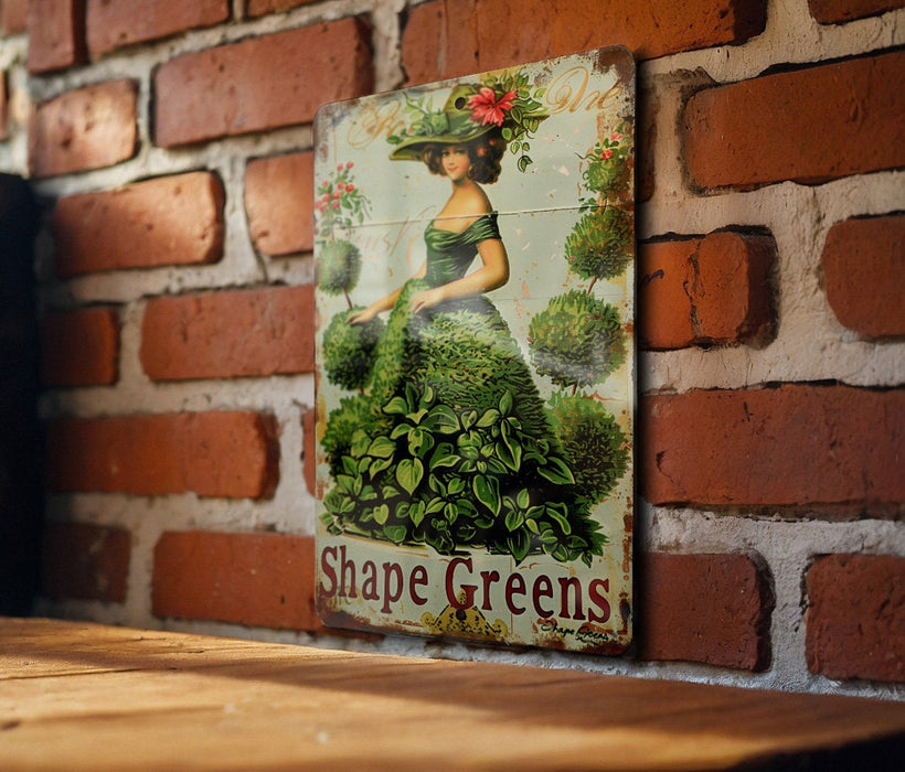 a picture of a woman in a green dress on a brick wall