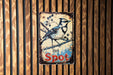 a blue bird sitting on top of a wooden sign