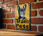a sign on a brick wall that says train pets