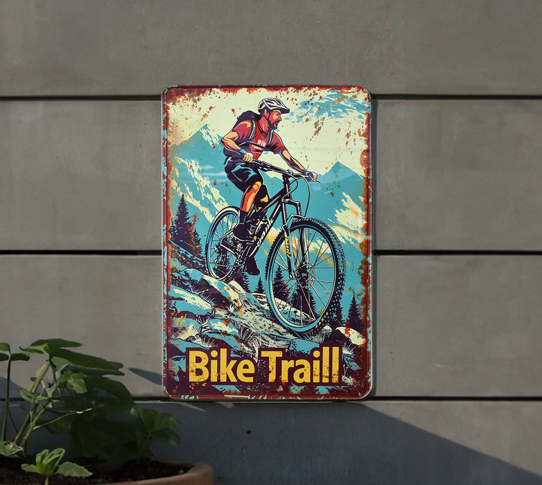 a bicycle trail sign hanging on the side of a building