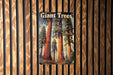 a picture of giant trees on a wooden wall