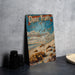 a book sitting on a table next to a pair of binoculars