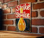 a sign on a brick wall that says strike strike