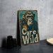 a sign that says care wild with a monkey on it