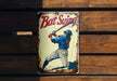 a tin sign with a baseball player holding a bat