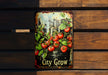 a sign that says city grow with tomatoes on it