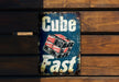 a sign that reads cube fast on a wooden bench