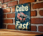 a sign that reads cube fast on a brick wall