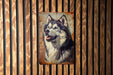 a picture of a husky dog on a rusted metal sign