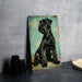 a black dog sitting on top of a table