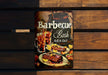 a barbeque sign hanging on a wooden wall